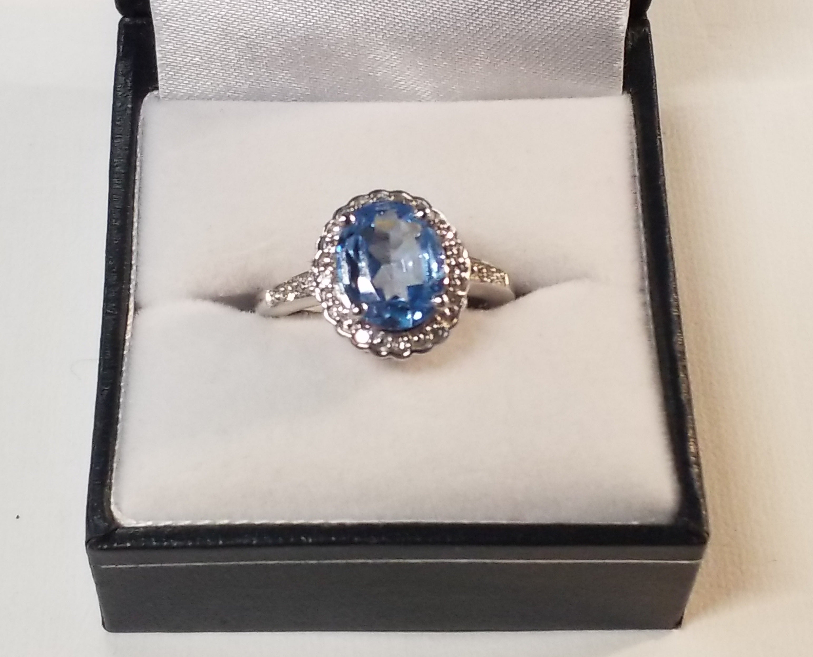 Oval Cut Blue Topaz Ring with Diamond Accents